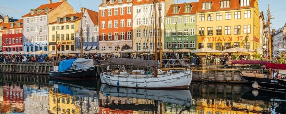 A solo female traveler biking through the streets of Copenhagen.